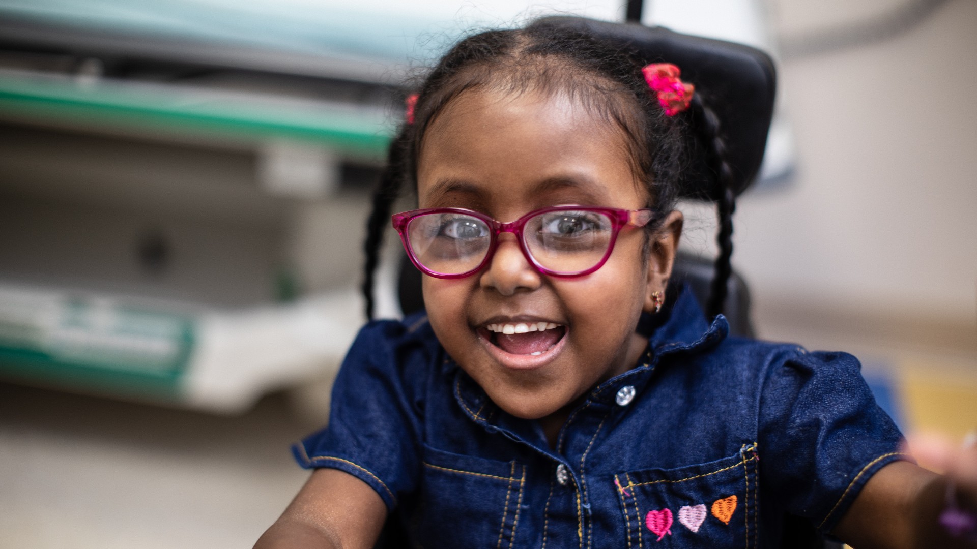 Young girl in wheelchair smiling